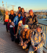 Group of students smiling with Kachemak Bay in background
